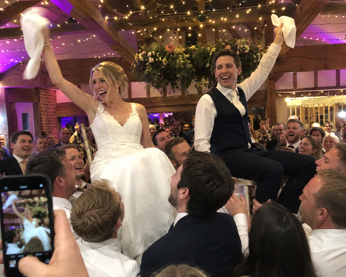 A bride and groom surrounded by wedding guests